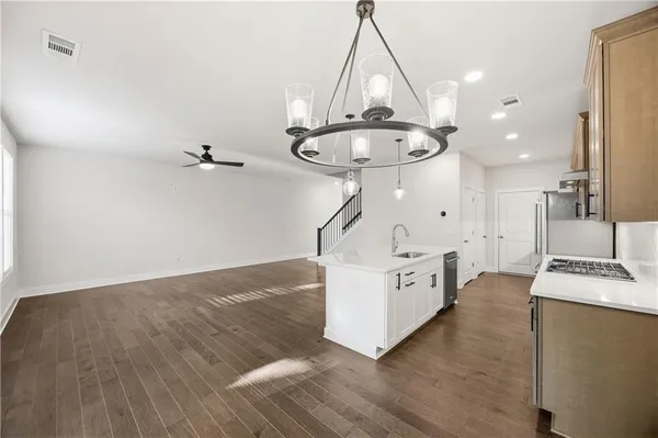 a view of kitchen with cabinets and wooden floor