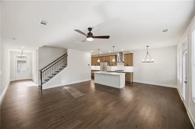a kitchen with stainless steel appliances a stove a sink and a refrigerator