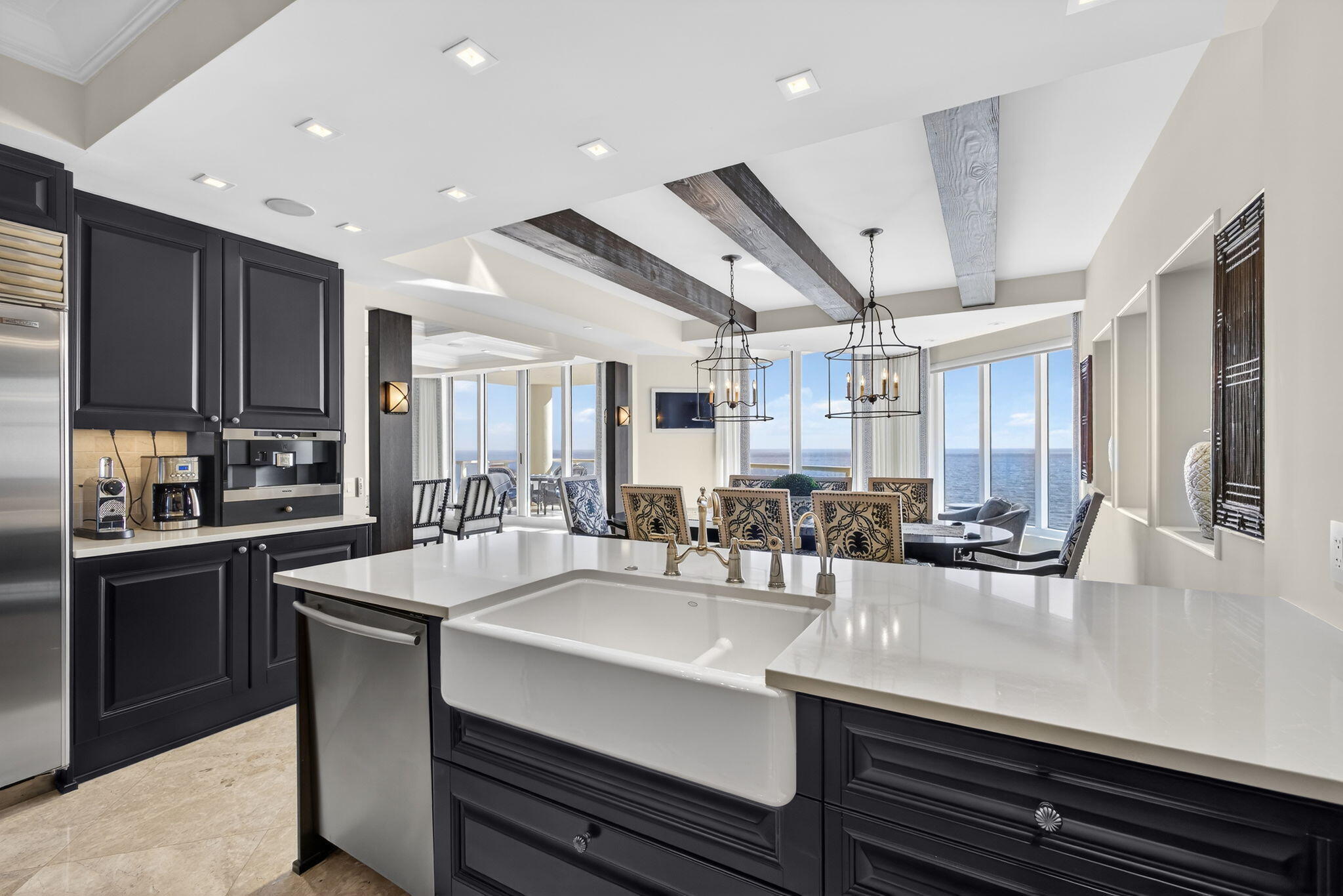 2700 North Ocean Drive, Unit 1401A Riviera Beach, FL 33404 - Photo 22 of 116 a kitchen with kitchen island a sink appliances and cabinets