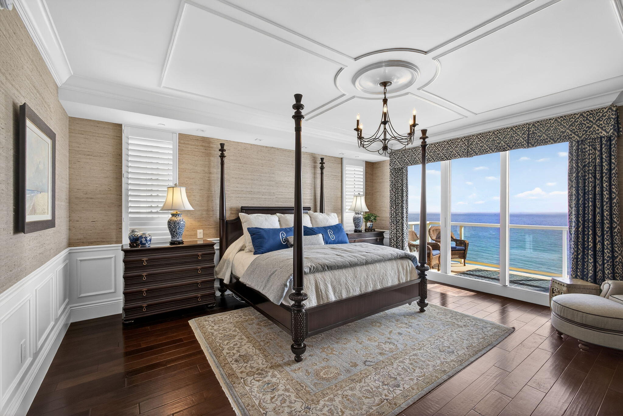 2700 North Ocean Drive, Unit 1401A Riviera Beach, FL 33404 - Photo 41 of 116 a bedroom with a bed a chandelier and large window