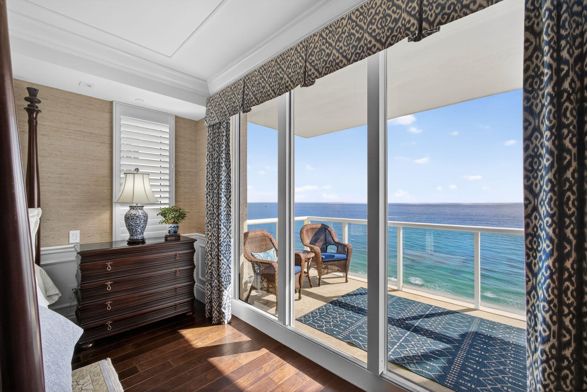 2700 North Ocean Drive, Unit 1401A Riviera Beach, FL 33404 - Photo 43 of 116 a room with a balcony a bed and glass door