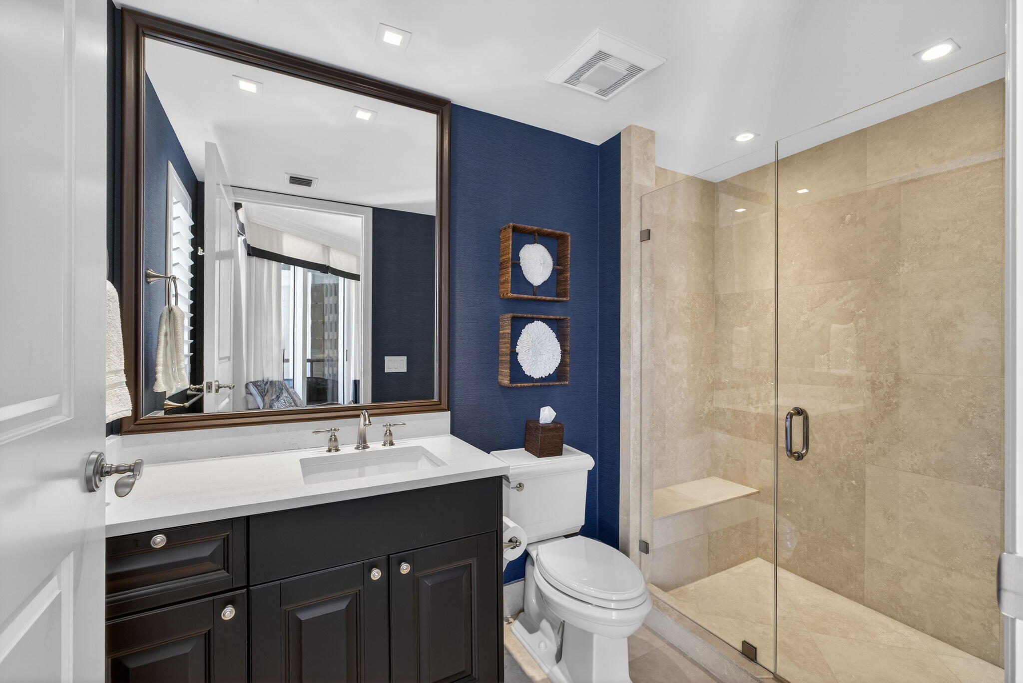 2700 North Ocean Drive, Unit 1401A Riviera Beach, FL 33404 - Photo 50 of 116 a bathroom with a double vanity sink toilet mirror and shower