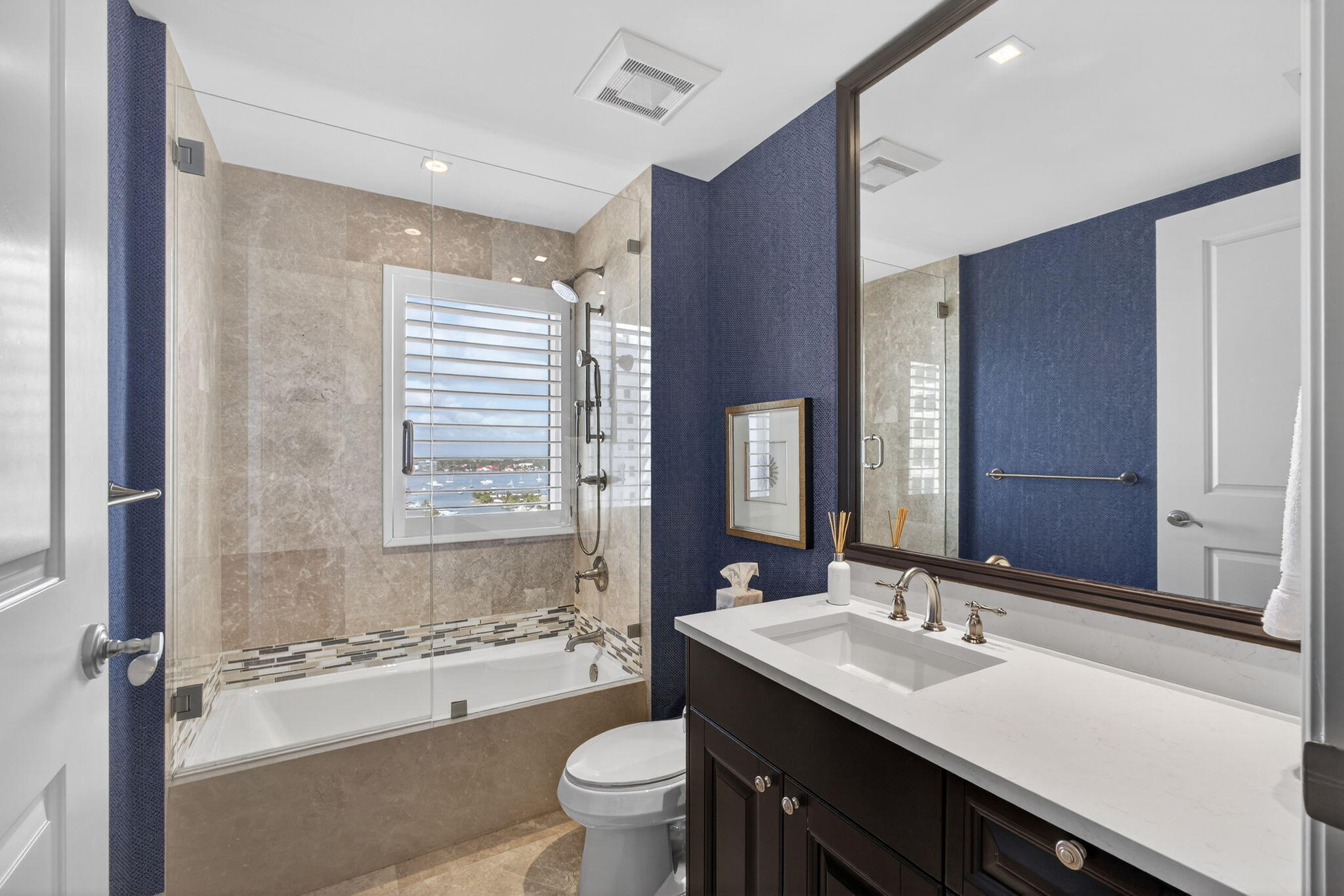 2700 North Ocean Drive, Unit 1401A Riviera Beach, FL 33404 - Photo 61 of 116 a bathroom with a sink double vanity granite tub toilet and a mirror