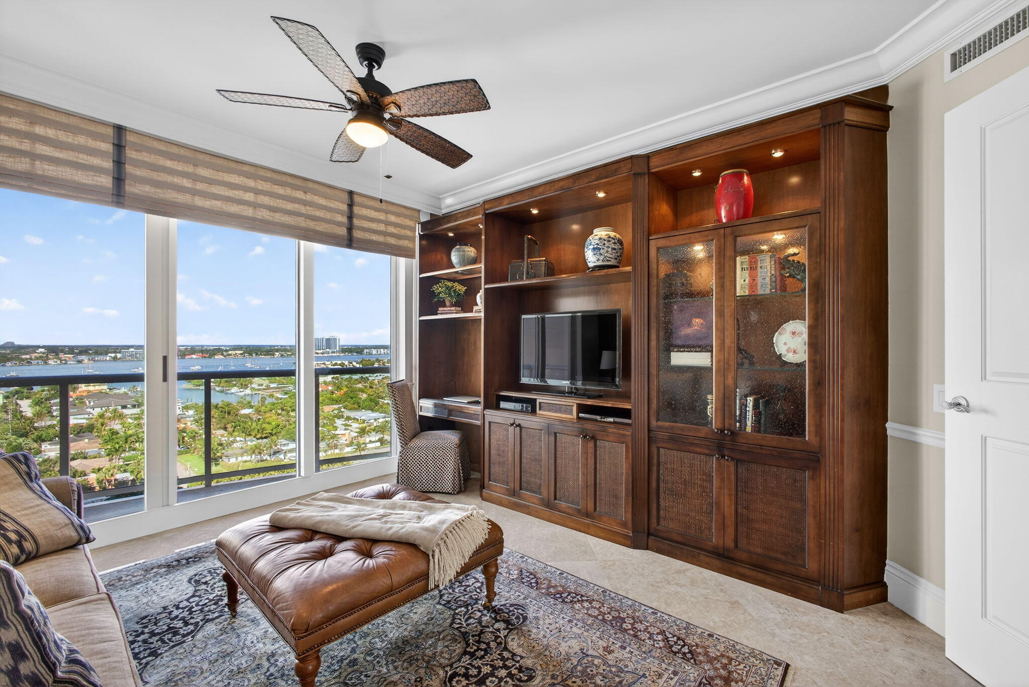 2700 North Ocean Drive, Unit 1401A Riviera Beach, FL 33404 - Photo 64 of 116 a living room with furniture a ceiling fan and a flat screen tv