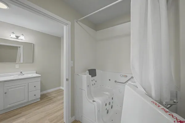 a bathroom with a double vanity sink mirror and toilet