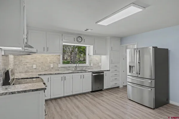 a kitchen with a sink stove and refrigerator