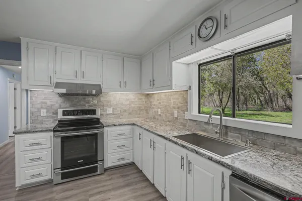 a kitchen with a stove and a sink