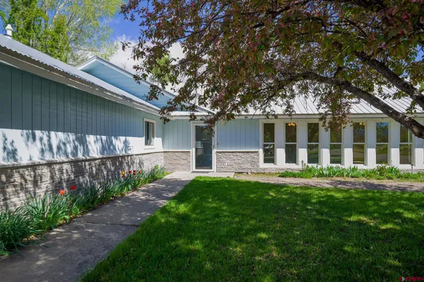 a front view of a house with a garden