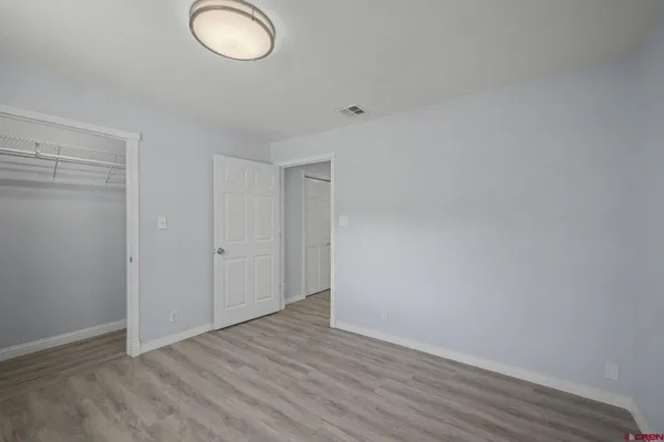 a view of an empty room and wooden floor