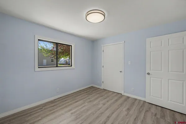 a view of room with wooden floor and window