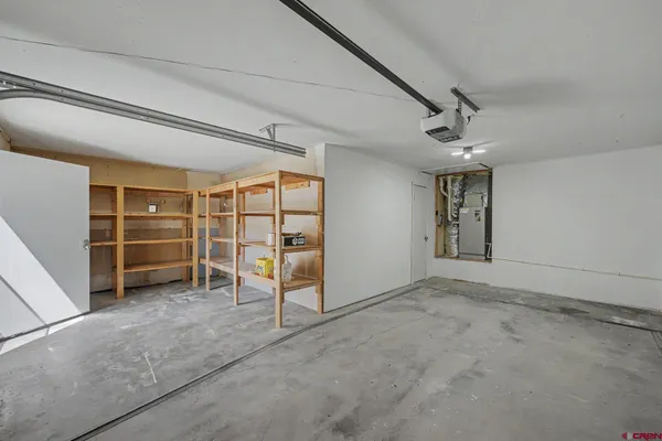 an empty room with a chair and closet