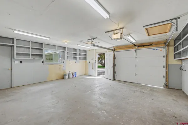 an empty room with closet and windows