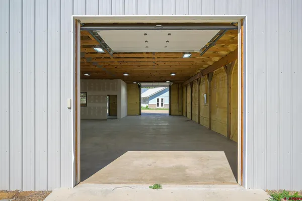 a view of a hallway with wooden floor and a fireplace