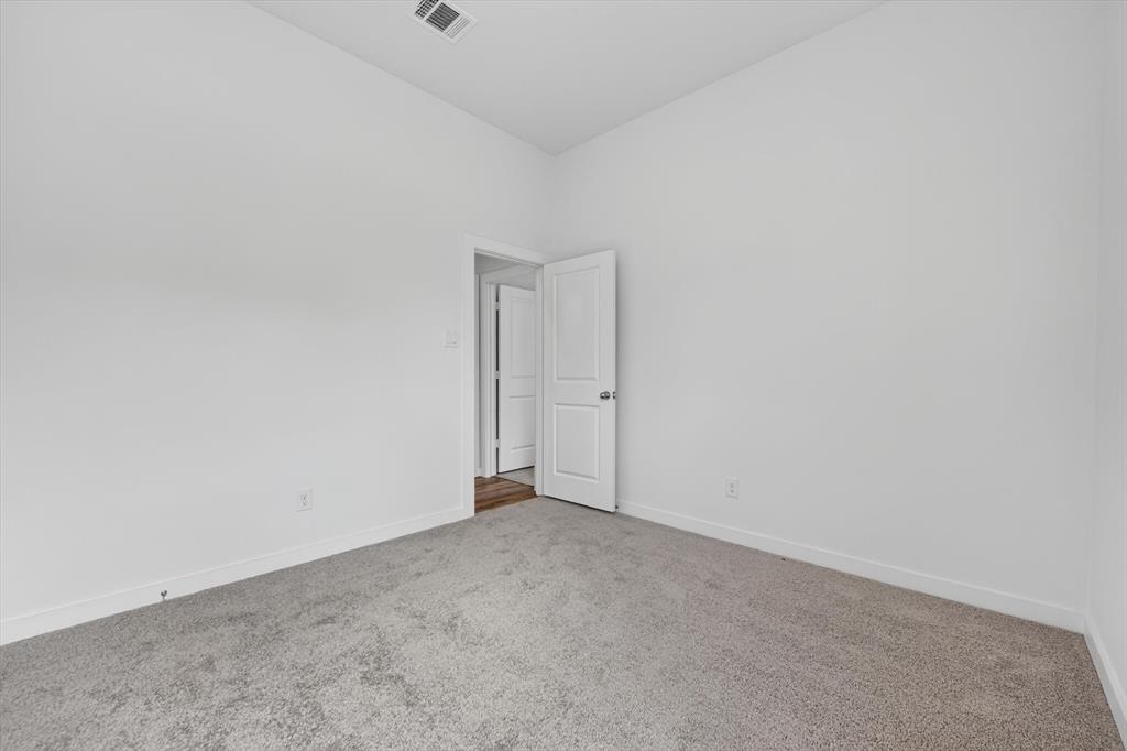 416 McAlpine Drive Springtown, TX 76082 - Photo 30 of 40 Room featuring light gray carpeting, white walls, white baseboards, and a white interior door with a silver handle