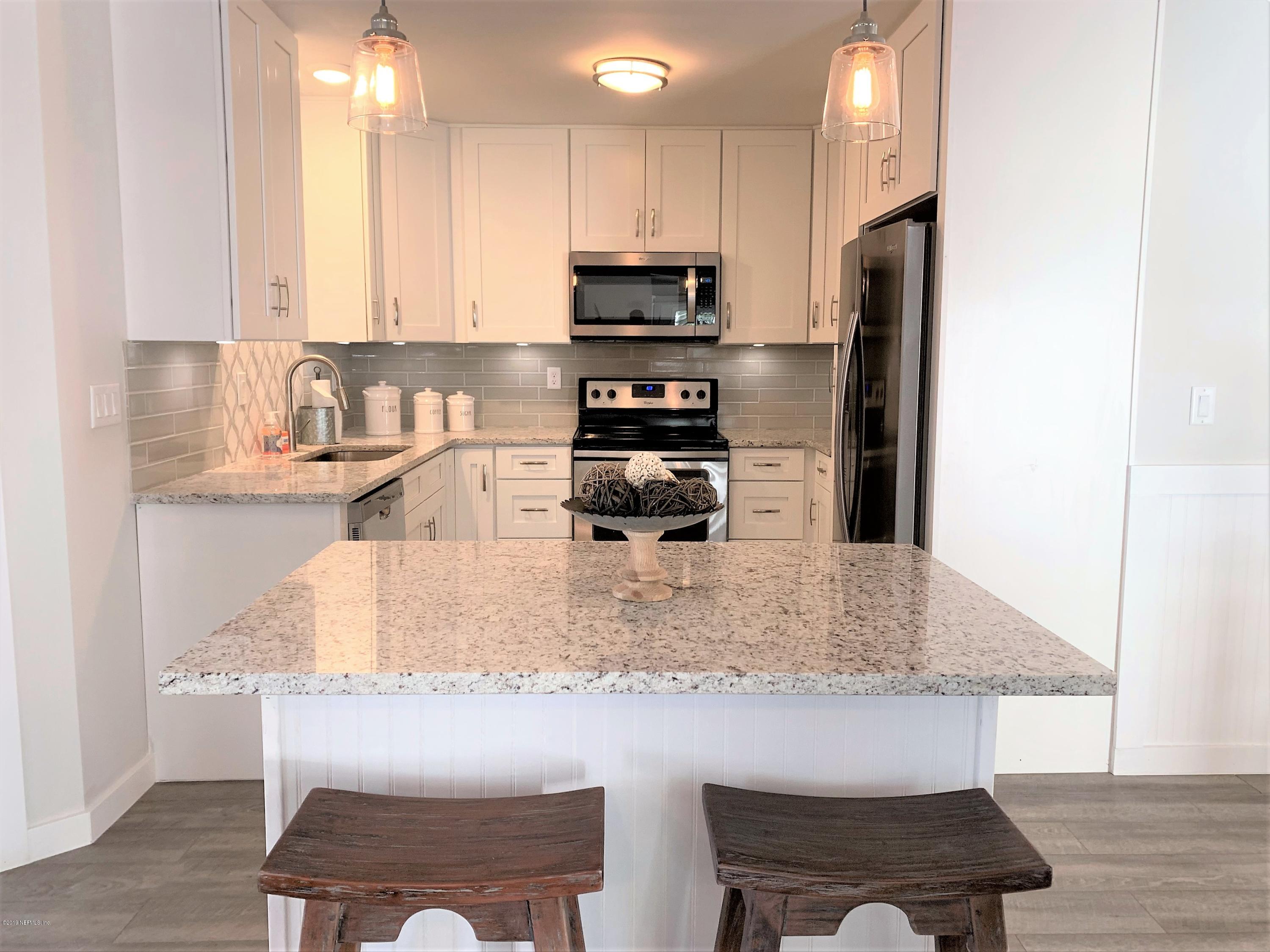 3300 Turtle Creek Road St. Augustine, FL 32086 - Photo 13 of 35 a kitchen with kitchen island granite countertop a stove and a refrigerator