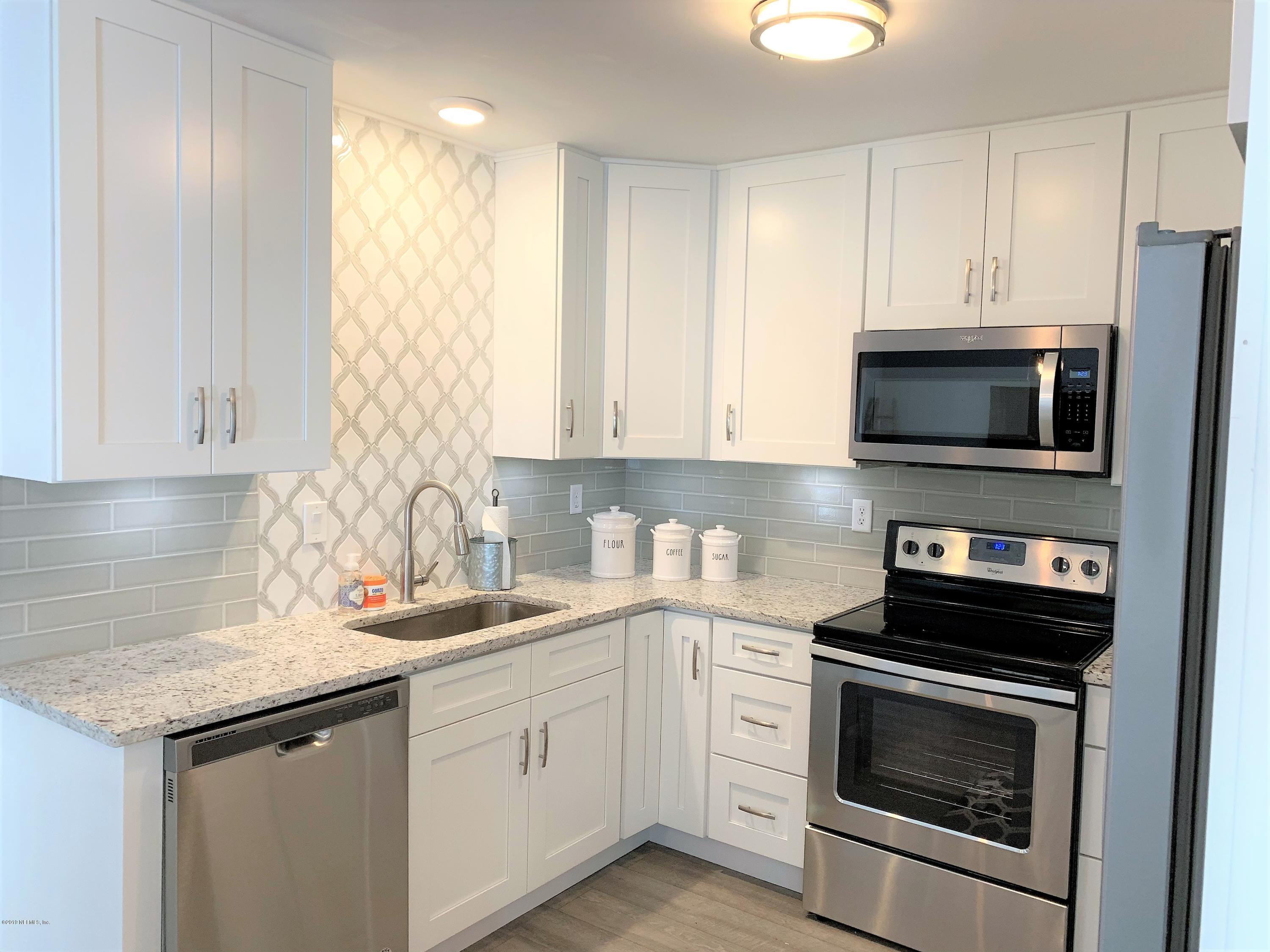 3300 Turtle Creek Road St. Augustine, FL 32086 - Photo 14 of 35 a kitchen with appliances a sink and cabinets