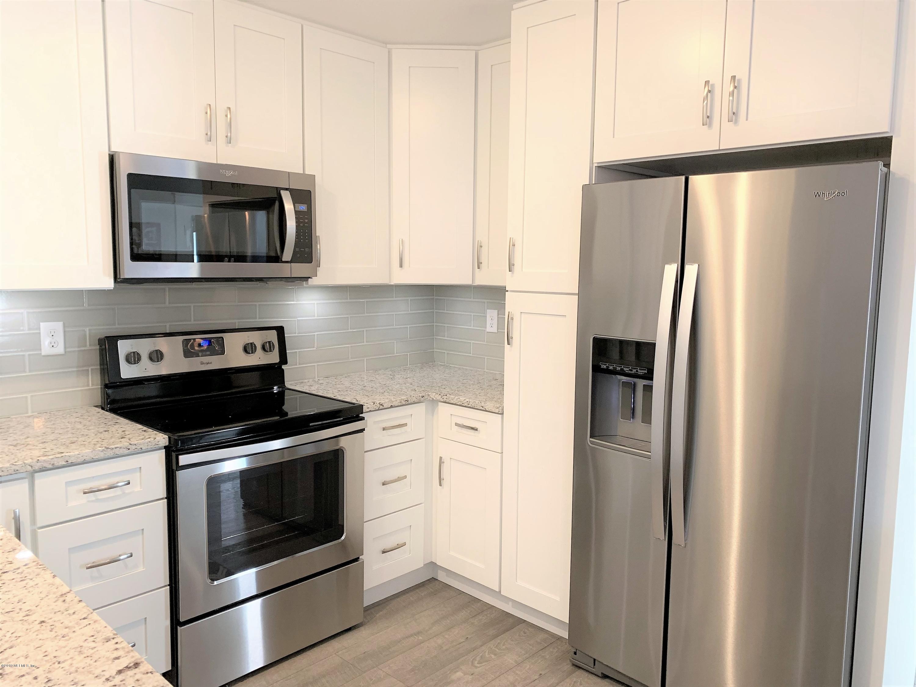 3300 Turtle Creek Road St. Augustine, FL 32086 - Photo 15 of 35 a kitchen with stainless steel appliances white cabinets and a stove