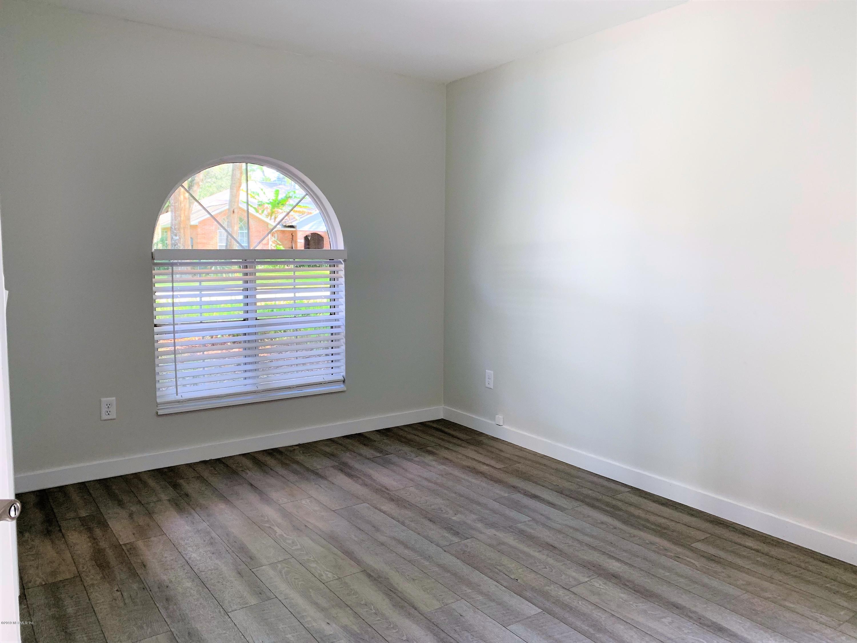 3300 Turtle Creek Road St. Augustine, FL 32086 - Photo 23 of 35 an empty room with wooden floor and windows
