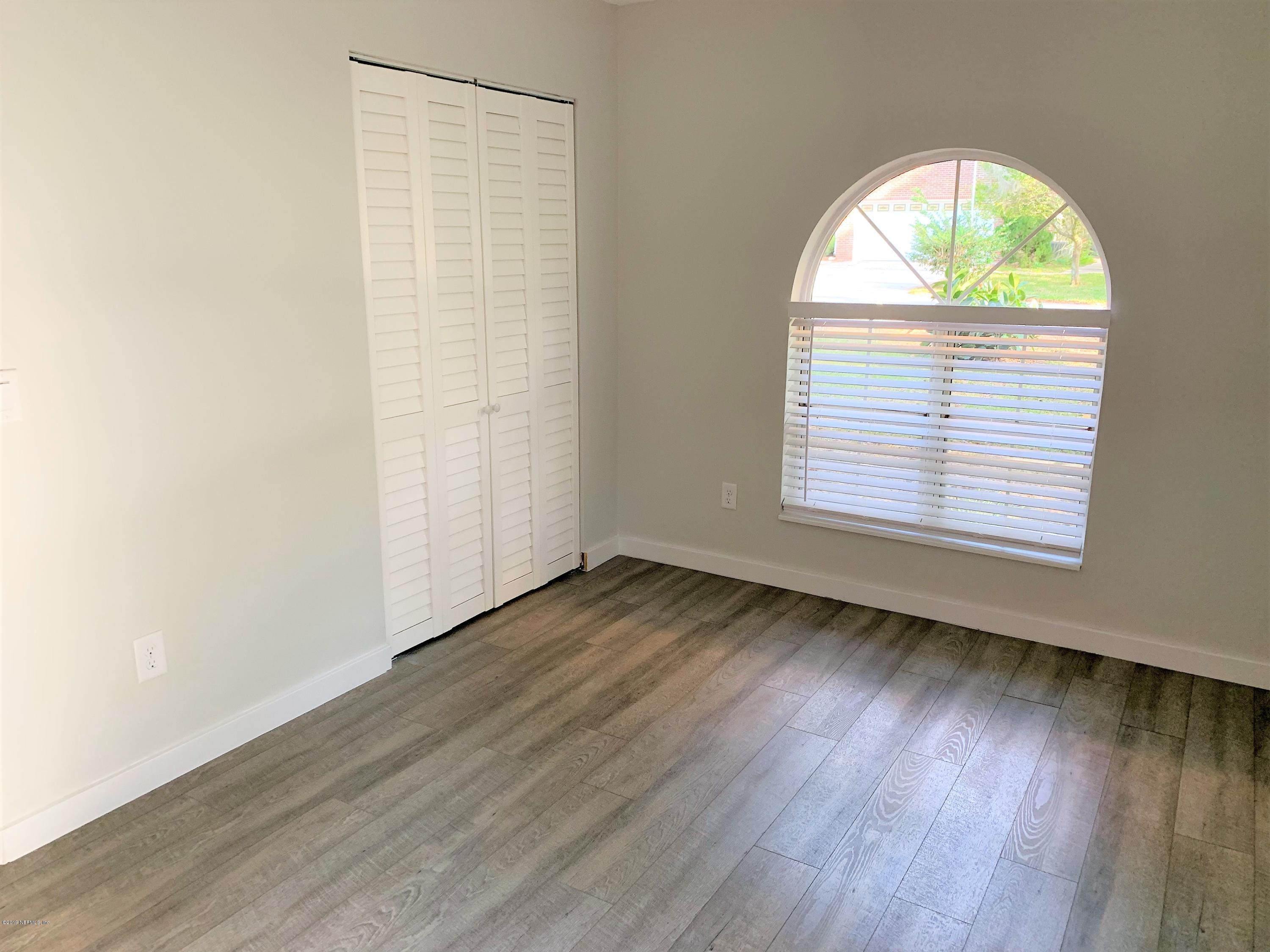 3300 Turtle Creek Road St. Augustine, FL 32086 - Photo 24 of 35 an empty room with wooden floor and windows