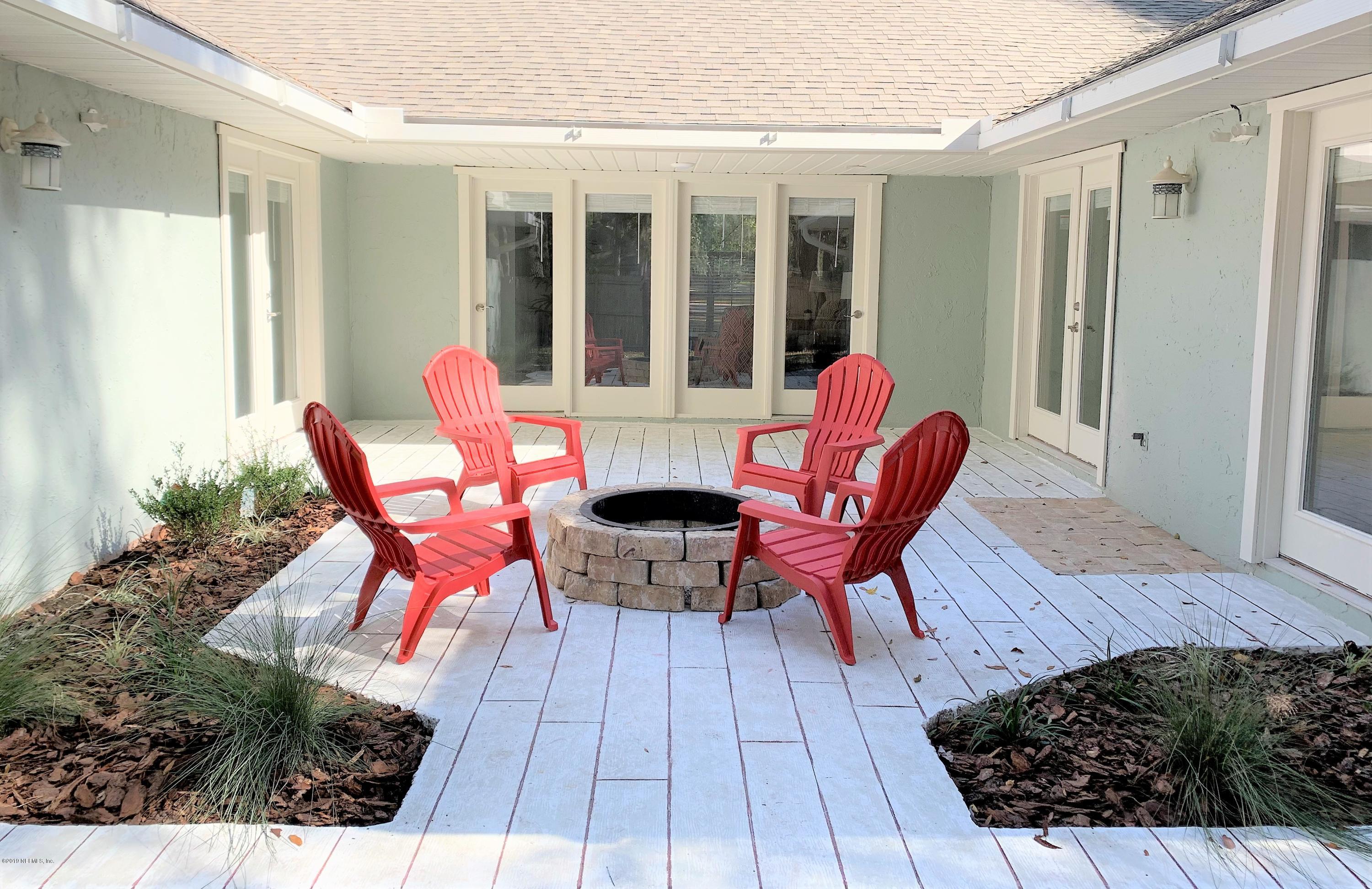 3300 Turtle Creek Road St. Augustine, FL 32086 - Photo 32 of 35 a view of a patio with table and chairs and potted plants