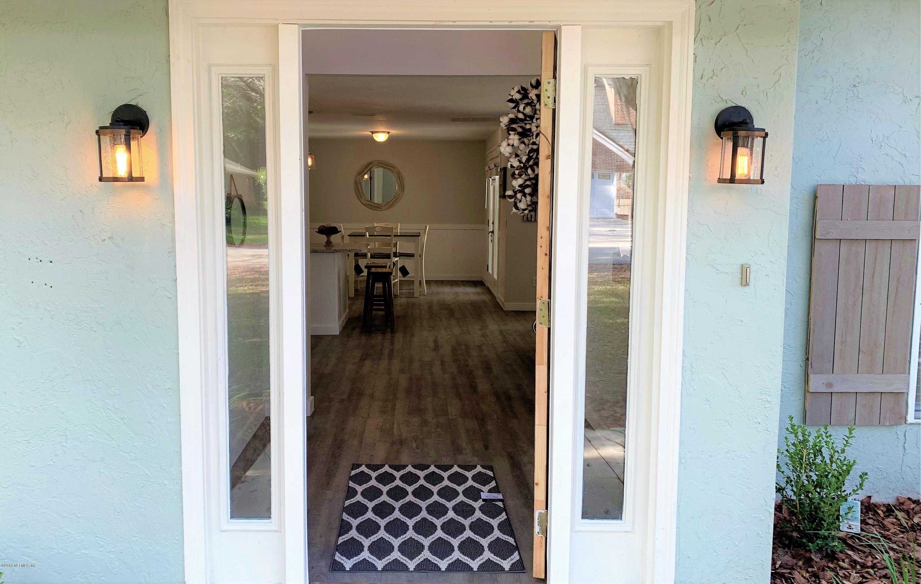 3300 Turtle Creek Road St. Augustine, FL 32086 - Photo 5 of 35 a view of a hallway with wooden floor and dining room