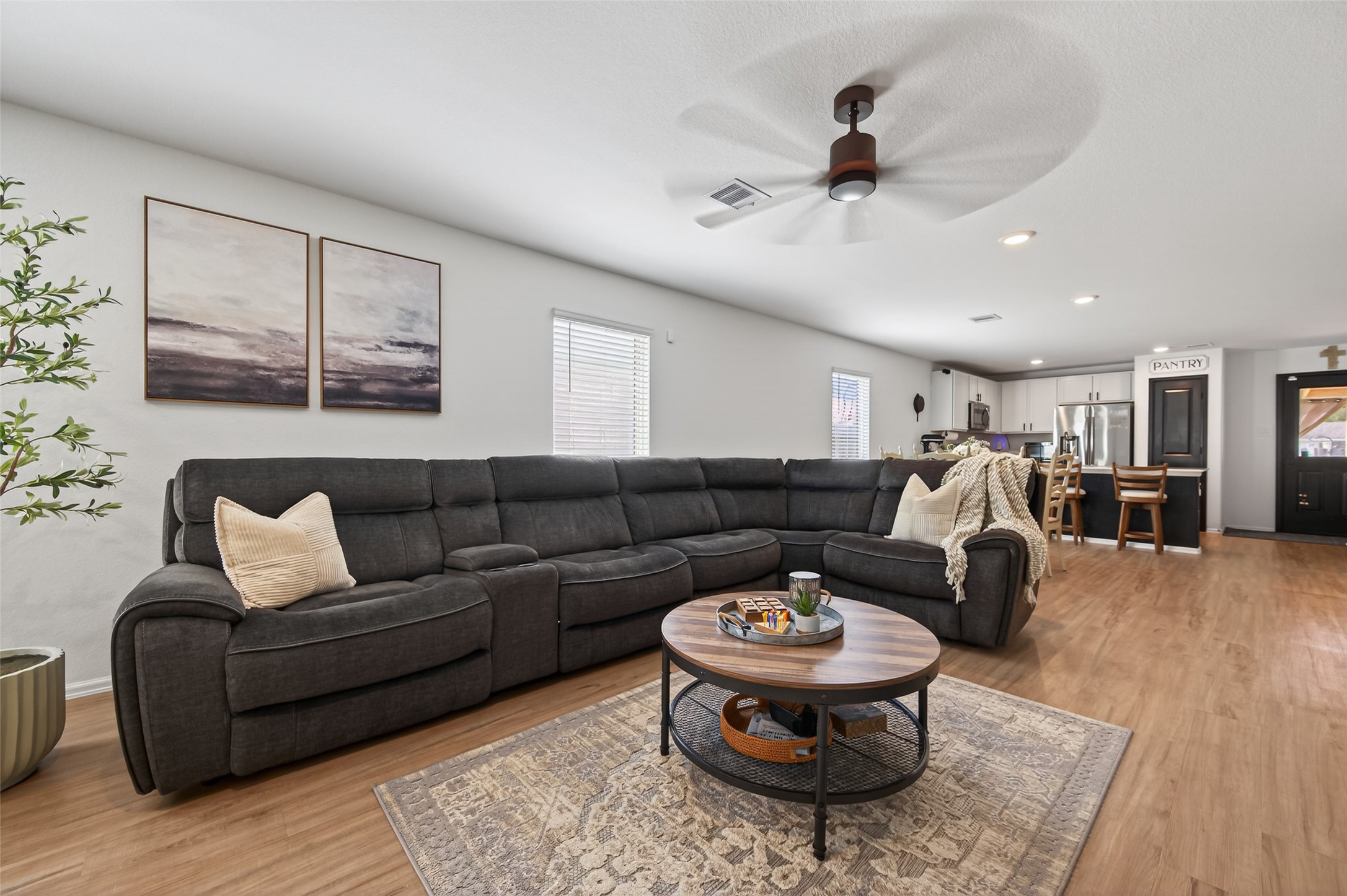 a living room with furniture a rug and white walls