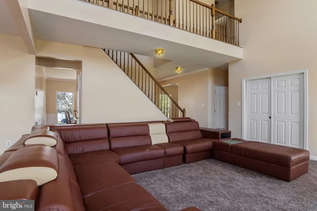 a living room with furniture and stairs