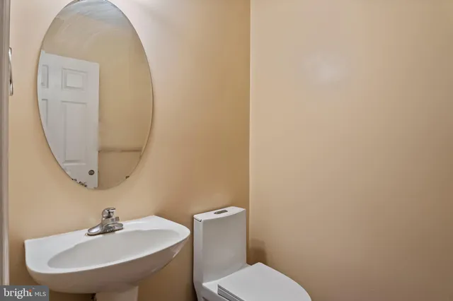 a bathroom with a sink a mirror and a toilet