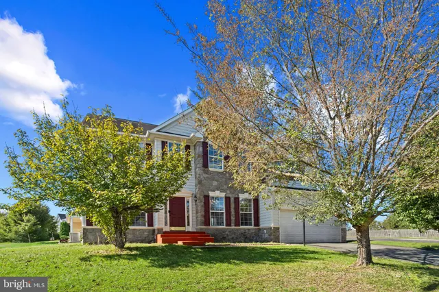 a front view of house with a garden