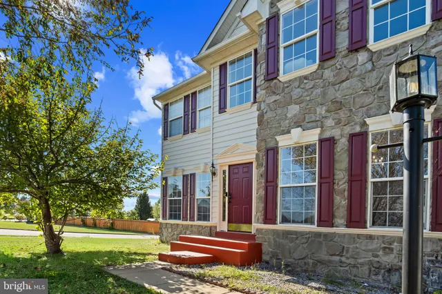 a front view of a building with a garden
