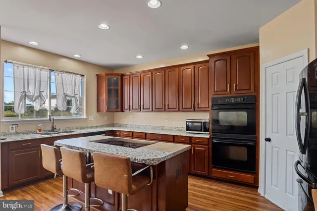 a kitchen with a sink stove and refrigerator