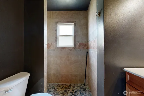 a bathroom with a toilet and a shower