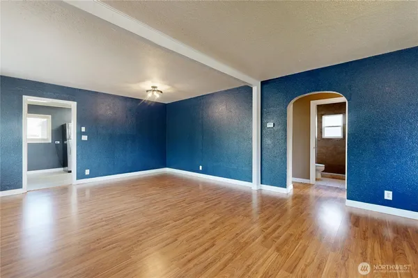 a view of empty room with wooden floor