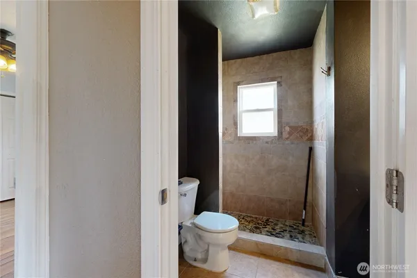 a bathroom with a toilet and a shower