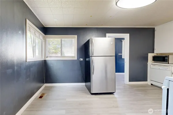 a refrigerator freezer sitting in a kitchen with stainless steel appliances granite countertop a refrigerator