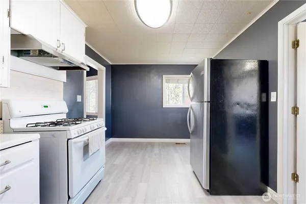a kitchen with a stove and a refrigerator