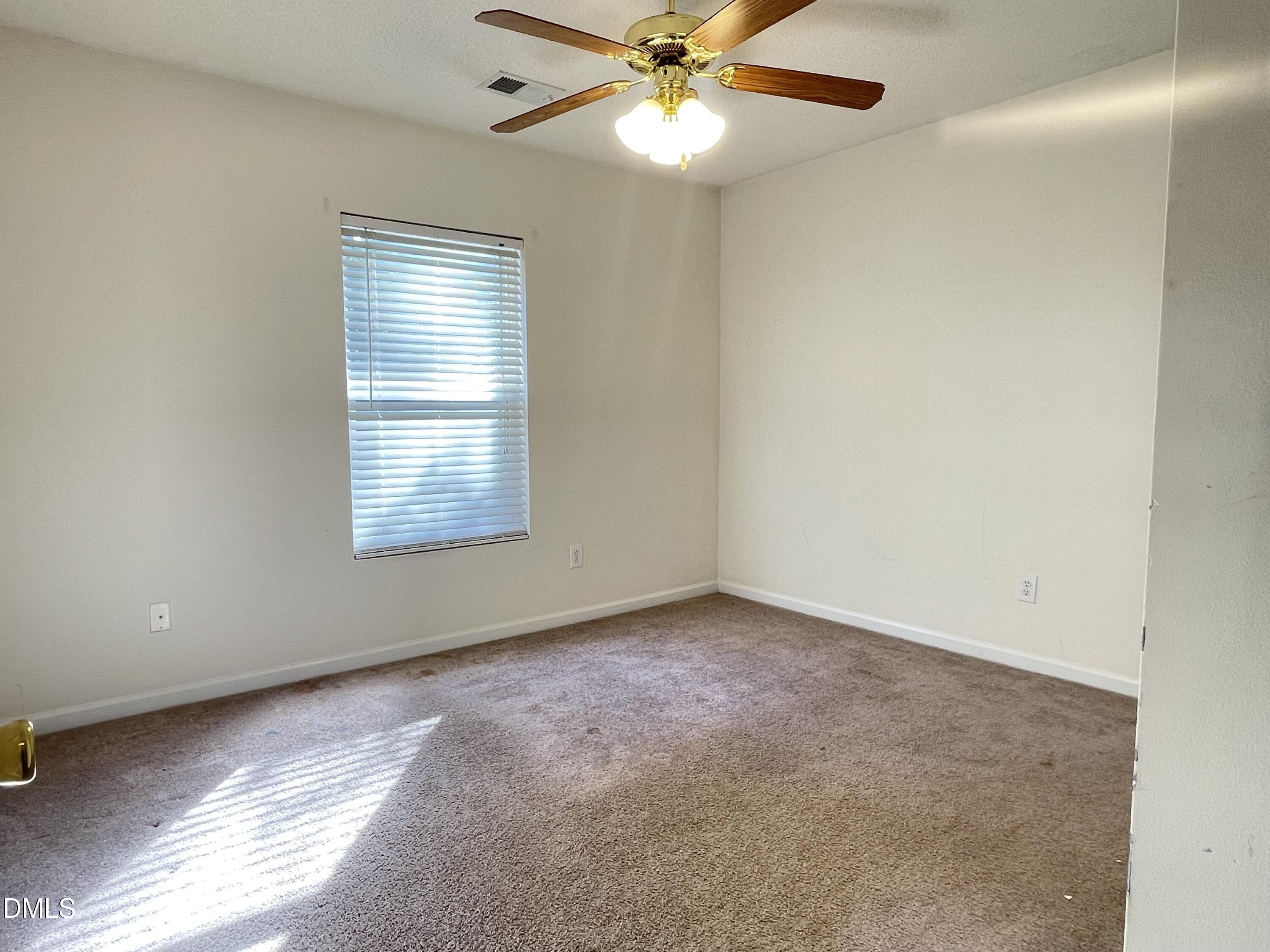 3616 Marshlane Way Raleigh, NC 27610 - Photo 16 of 24 an empty room with a window and a fan