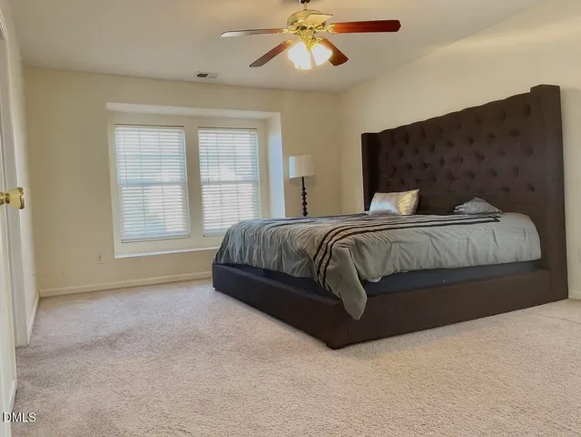 a bedroom with a bed and window