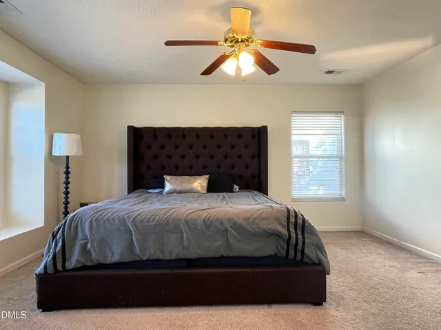 a bedroom with a bed and window