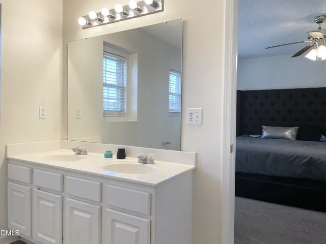 a en suite bathroom with a sink and a mirror