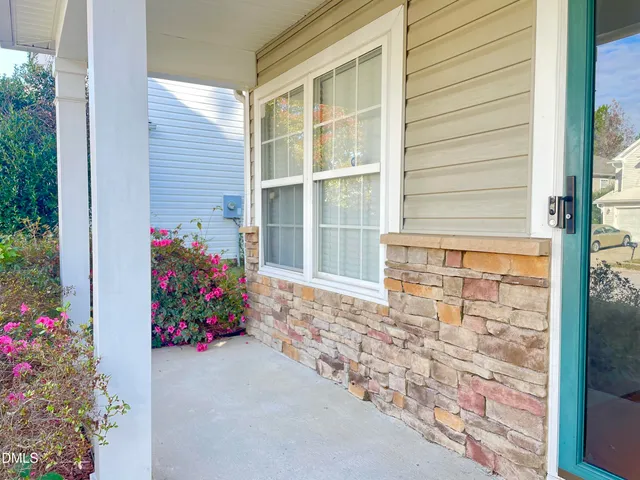 a bunch of flowers in front of house