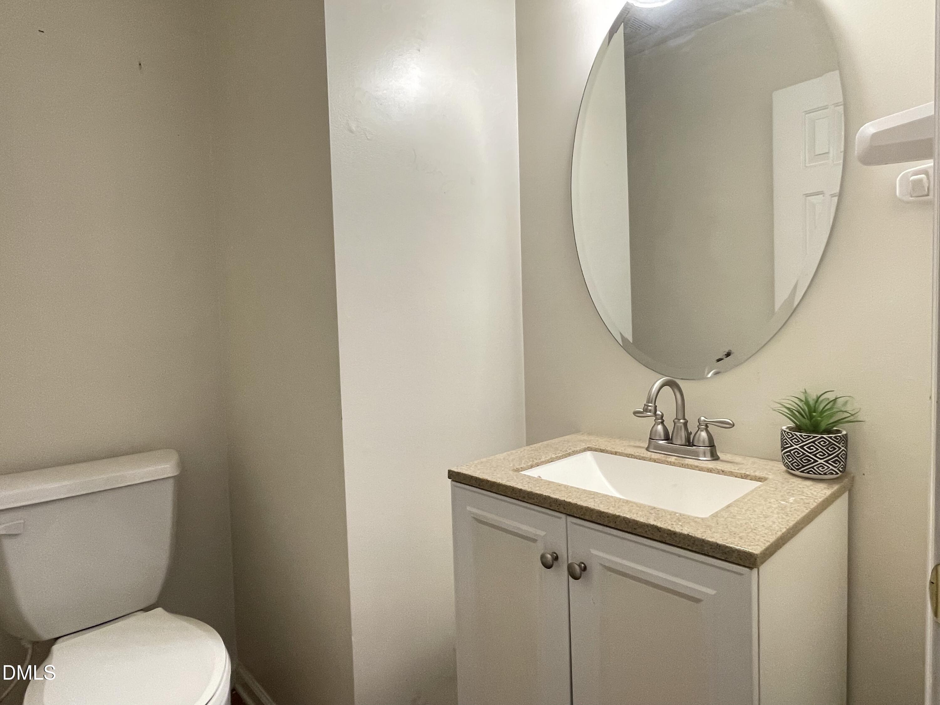 3616 Marshlane Way Raleigh, NC 27610 - Photo 6 of 24 a bathroom with a toilet sink and mirror
