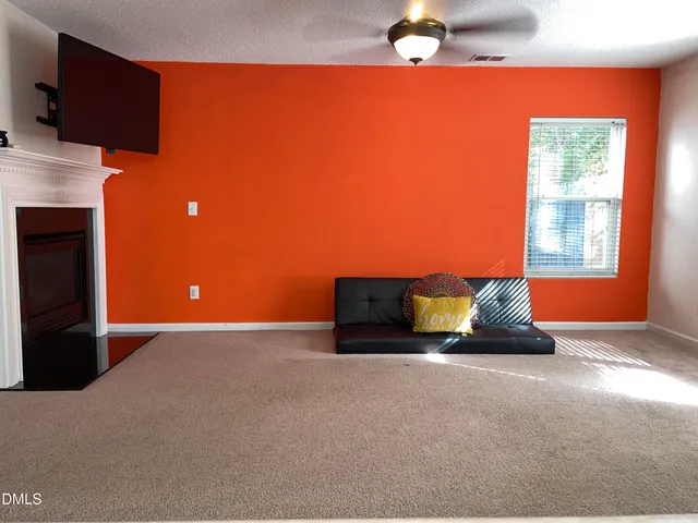 a room with a bed and a fireplace