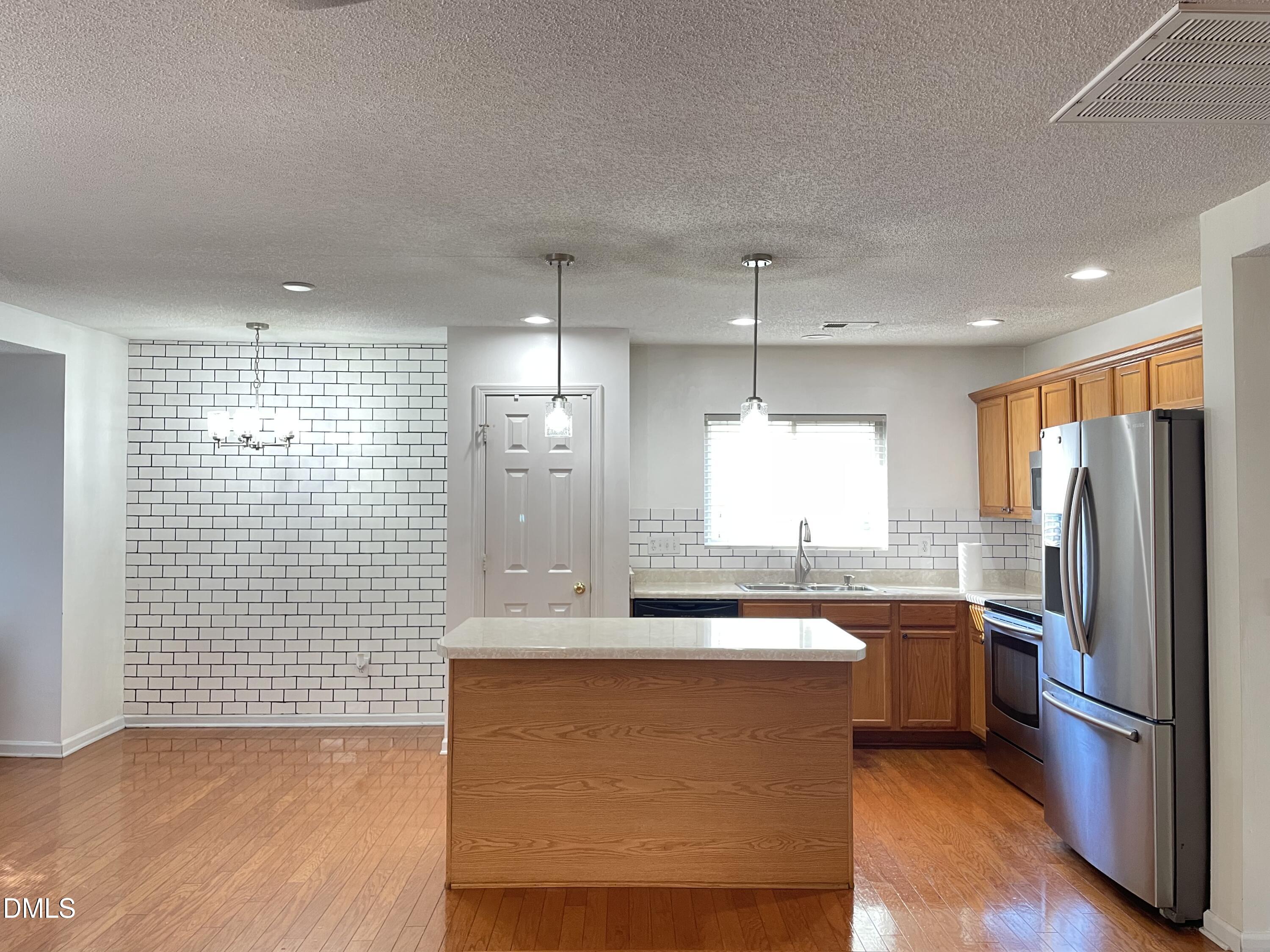 3616 Marshlane Way Raleigh, NC 27610 - Photo 8 of 24 a kitchen with stainless steel appliances granite countertop a sink a refrigerator and a stove