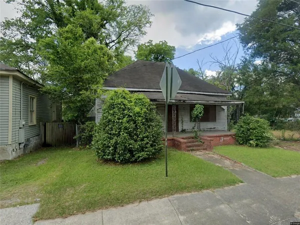 a front view of a house with garden