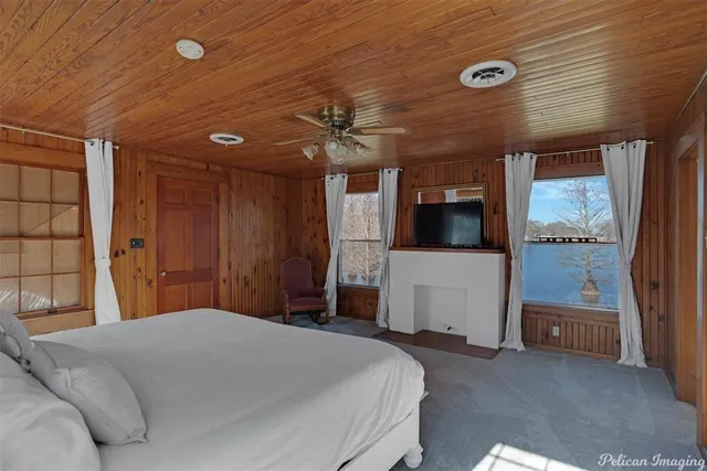 a bedroom with a bed and a television