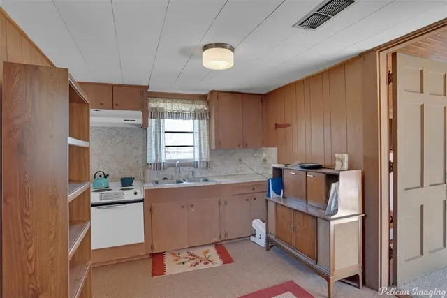 a room with a sink and a refrigerator