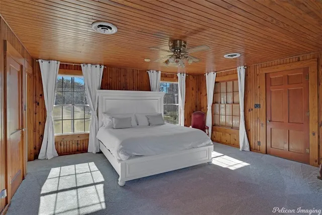 a spacious bedroom with a bed a window and walk in closet