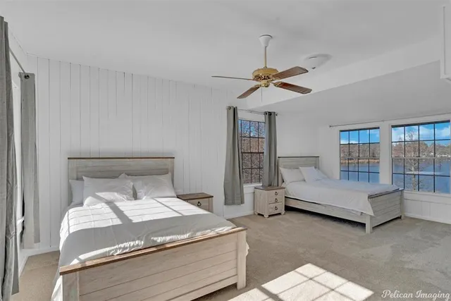 a bedroom with a bed and a ceiling fan