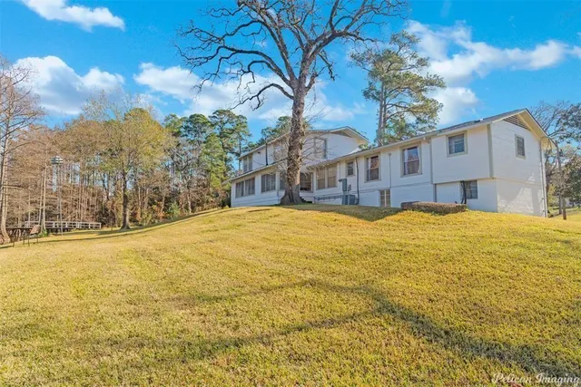 a view of a lake with lawn chairs
